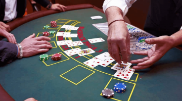 photo of a blackjack table with cards and chips