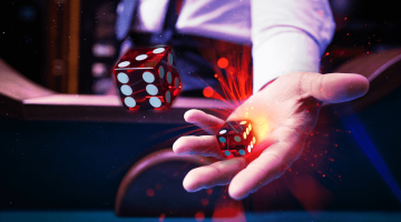image showing a dealer throwing two craps dice in the air